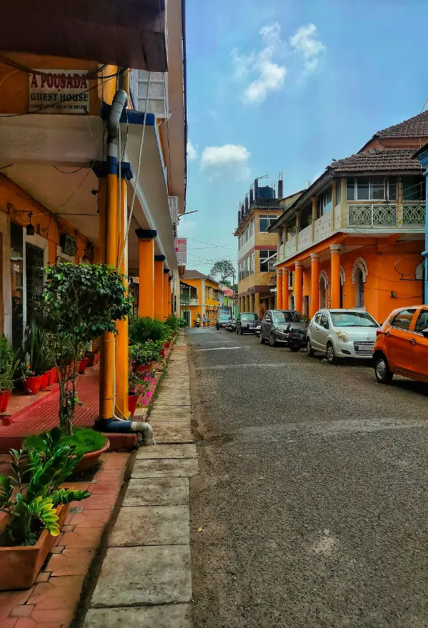 This image captures a quiet moment on a street in the historic Fontainhas neighborhood of Panjim, Goa, India. 