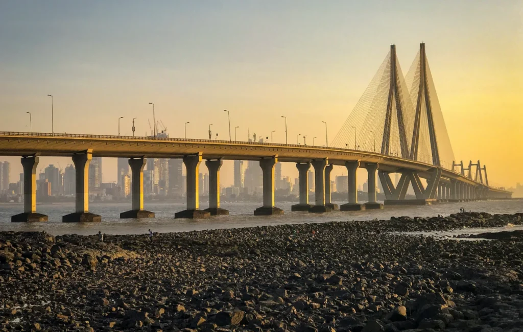 This image shows the Bandra-Worli Sea Link, a major landmark in Mumbai, India, during sunset. 