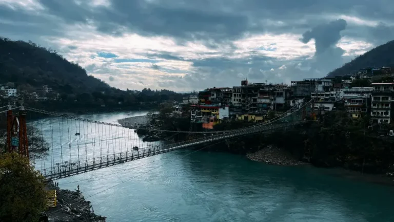 A scenic moment at Ram Jhula in Rishikesh, Uttarakhand, where the holy Ganges river flows through the Himalayan foothills.
