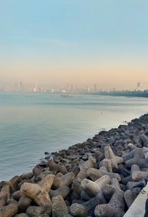 This image captures a quiet moment at Marine Drive in Mumbai, specifically looking towards the South Mumbai skyline from the promenade. 
